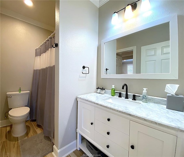 801 Luther St W Unit 1407, College Station, TX 77840 - bathroom with wood finished floors, toilet, vanity, and baseboards