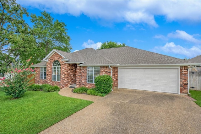 2308 Kuykendall Cir, Bryan, TX 77808 - view of front facade featuring driveway, brick siding, an attached garage, and a front lawn