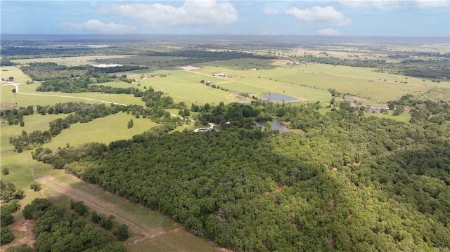 birds eye view of property with a forest view and a rural view