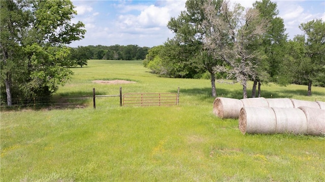 view of yard featuring fence and a rural view