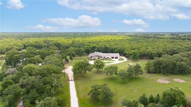 drone / aerial view with a wooded view