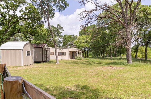 view of yard with a storage unit and an outbuilding