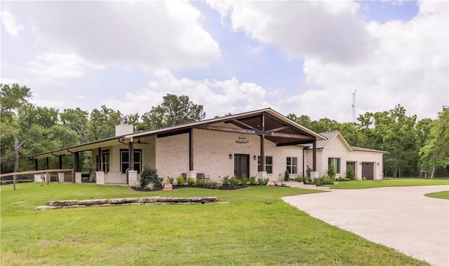exterior space with a lawn, driveway, a chimney, and a garage