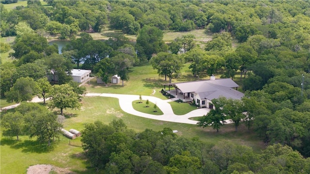 drone / aerial view featuring a wooded view