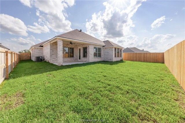 back of house featuring a lawn, a patio area, and ceiling fan