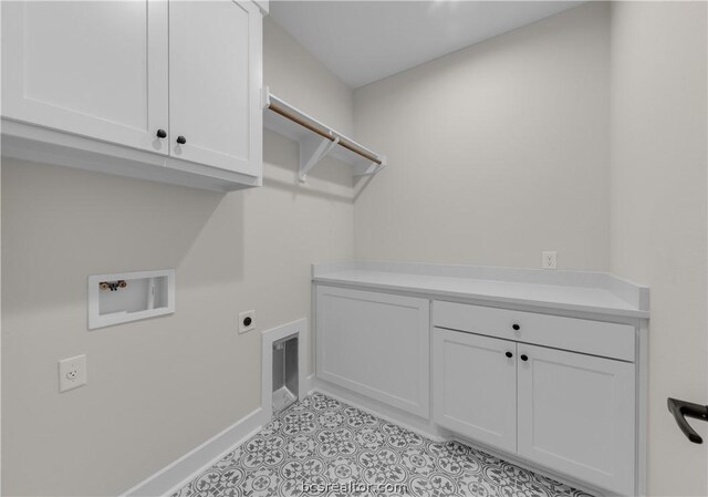 laundry room with hookup for an electric dryer, cabinets, and washer hookup