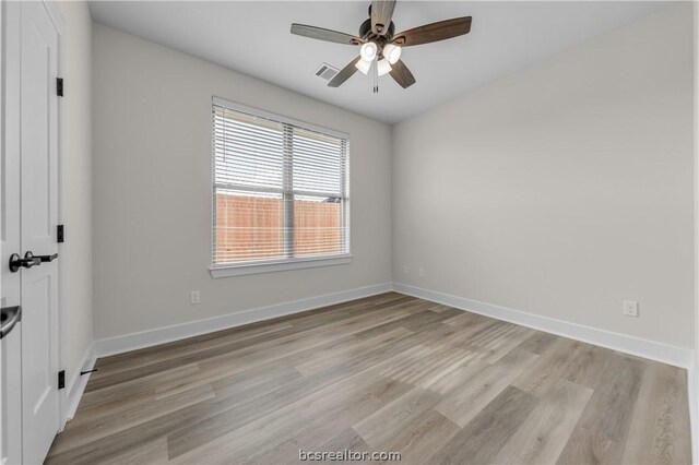 empty room with ceiling fan and light hardwood / wood-style flooring