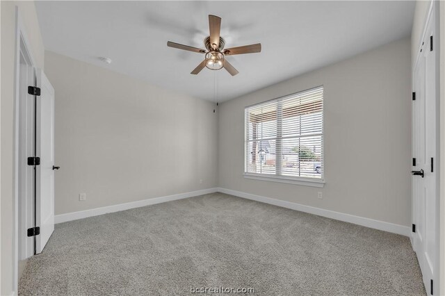 carpeted empty room with ceiling fan