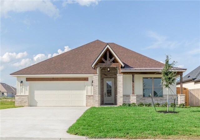 view of front of home featuring a garage and a front lawn