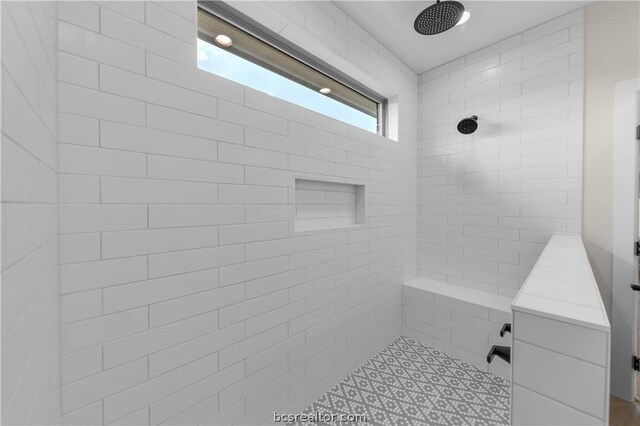 bathroom with a wealth of natural light and tiled shower