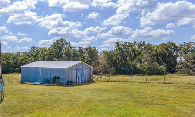 view of yard with an outbuilding and a rural view