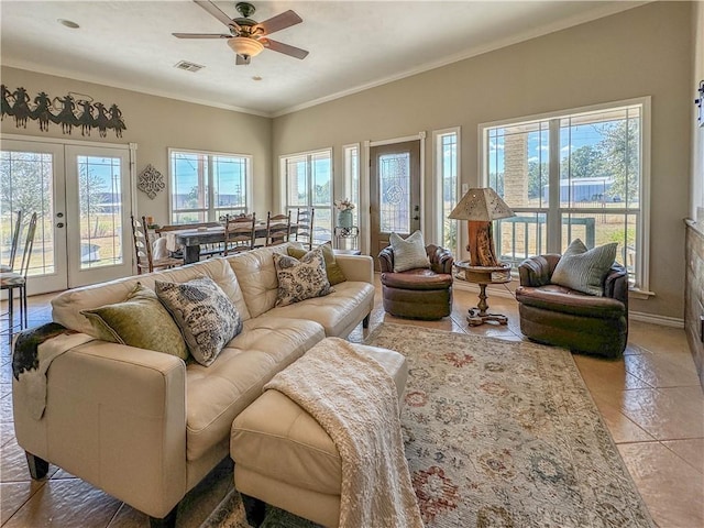 tiled living room featuring french doors, ceiling fan, and a healthy amount of sunlight