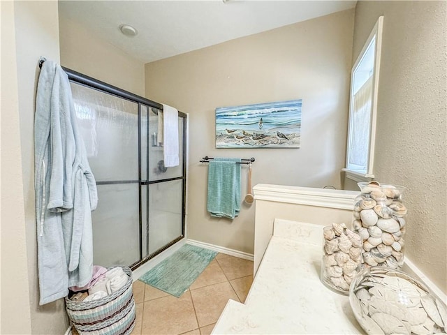 bathroom featuring tile patterned flooring and a shower with door