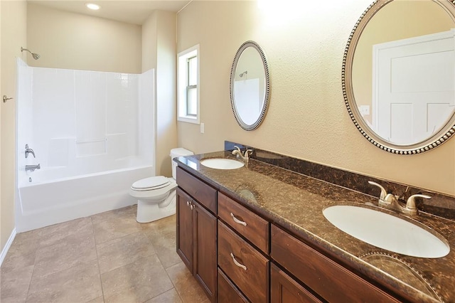 full bathroom with tile patterned floors, vanity, tub / shower combination, and toilet