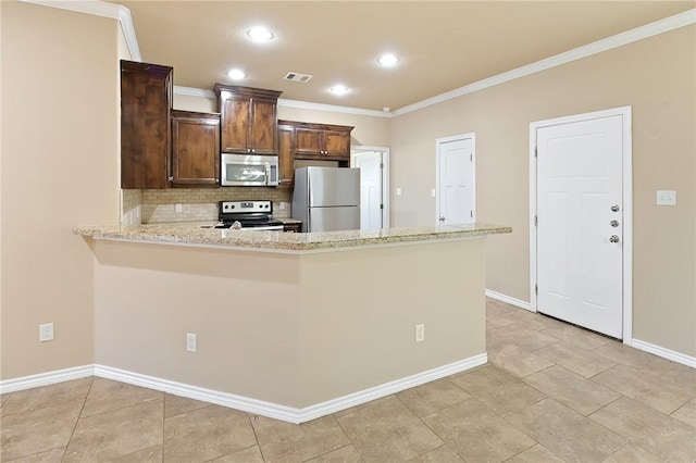 kitchen featuring crown molding, tasteful backsplash, light stone counters, kitchen peninsula, and stainless steel appliances