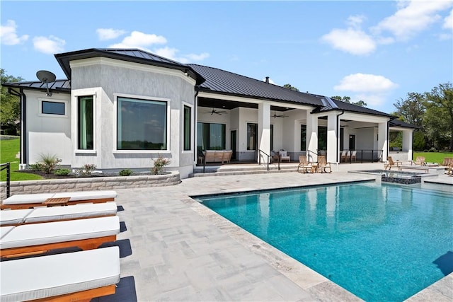 rear view of house with ceiling fan, a swimming pool with hot tub, an outdoor living space, and a patio