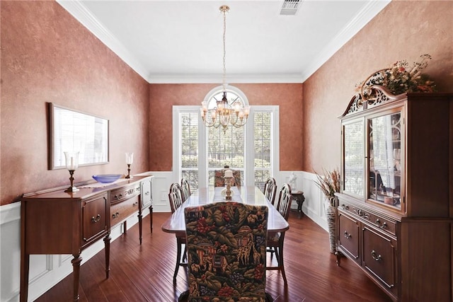 4304 Newcastle Ct, Bryan, TX 77802 - dining space featuring ornamental molding, dark wood-style floors, a chandelier, and visible vents