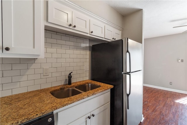 kitchen featuring stainless steel refrigerator, white cabinetry, dark wood-type flooring, and dark stone counters