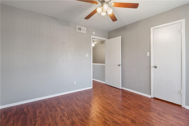 unfurnished bedroom with ceiling fan and dark hardwood / wood-style flooring