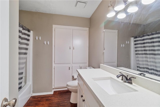 full bathroom with vanity, hardwood / wood-style flooring, toilet, and shower / bathtub combination with curtain