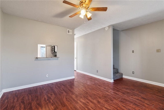 spare room with a textured ceiling, dark hardwood / wood-style flooring, and ceiling fan