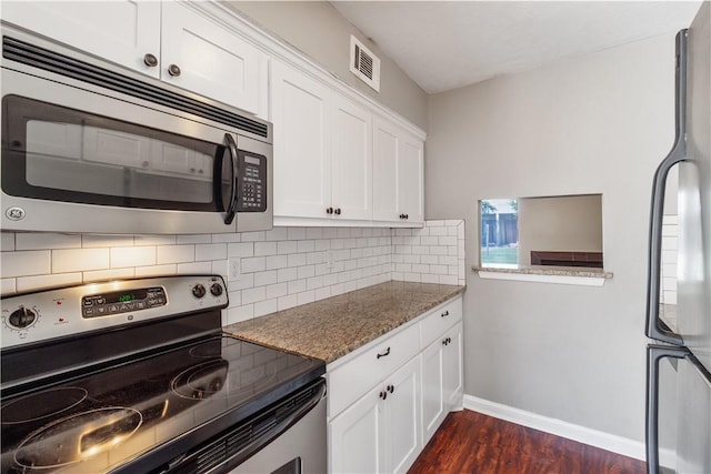 kitchen with decorative backsplash, stainless steel appliances, stone countertops, dark hardwood / wood-style floors, and white cabinetry