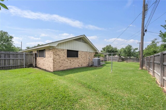 view of property exterior featuring brick siding and central AC