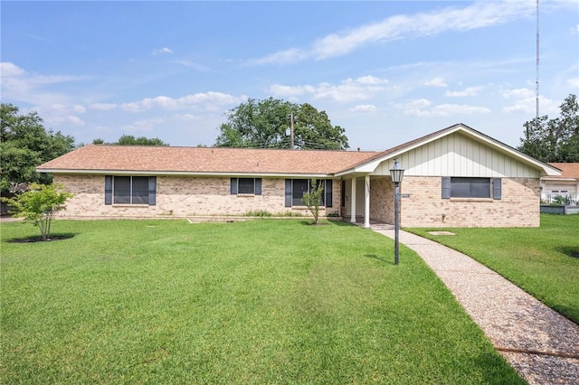 ranch-style home with brick siding and a front yard