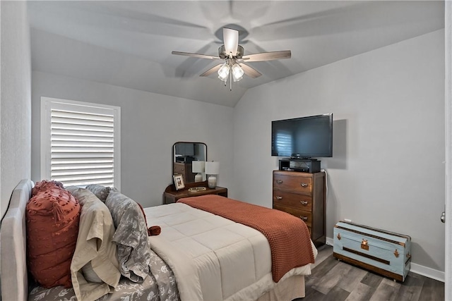 bedroom with lofted ceiling, ceiling fan, wood finished floors, and baseboards