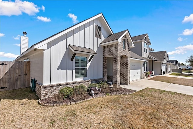 view of property exterior with brick siding, concrete driveway, board and batten siding, fence, and a garage