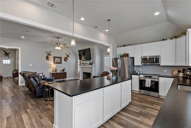 kitchen with dark countertops, visible vents, and stainless steel appliances