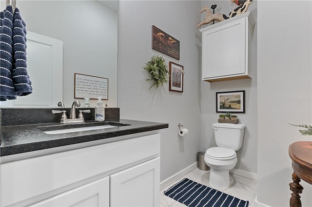 half bathroom featuring toilet, marble finish floor, baseboards, and vanity