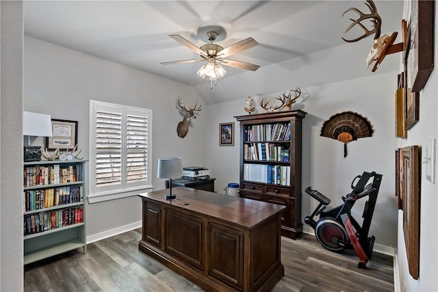 home office with ceiling fan, dark wood-type flooring, lofted ceiling, and baseboards