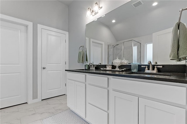 full bath with a stall shower, marble finish floor, visible vents, and a sink