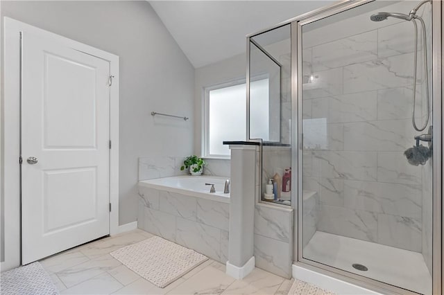 bathroom featuring marble finish floor, vaulted ceiling, a shower stall, and a bath