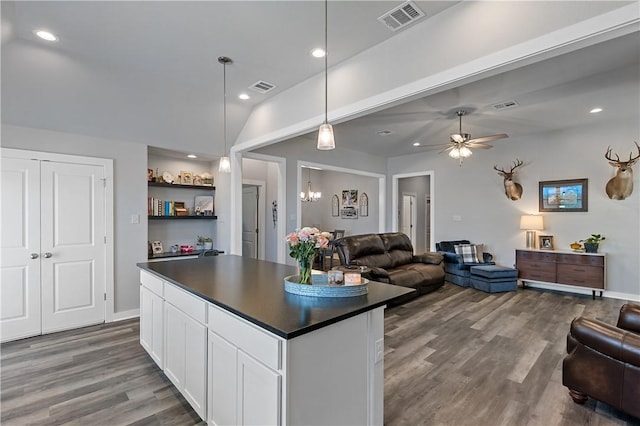 kitchen featuring open floor plan, dark countertops, dark wood finished floors, and visible vents