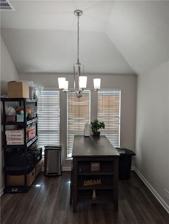 dining area with dark wood-type flooring, lofted ceiling, and a notable chandelier