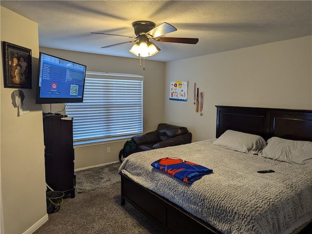 bedroom featuring ceiling fan, carpet, and a textured ceiling