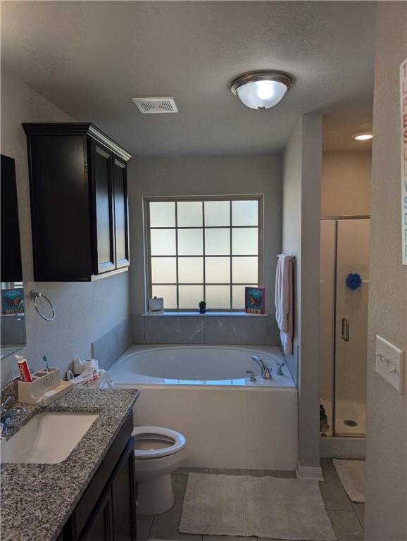 full bathroom with vanity, tile patterned flooring, toilet, and separate shower and tub