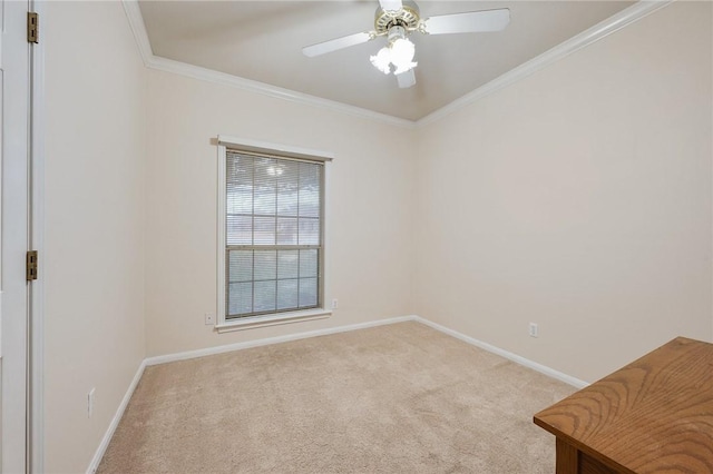 spare room with crown molding, light carpet, and ceiling fan