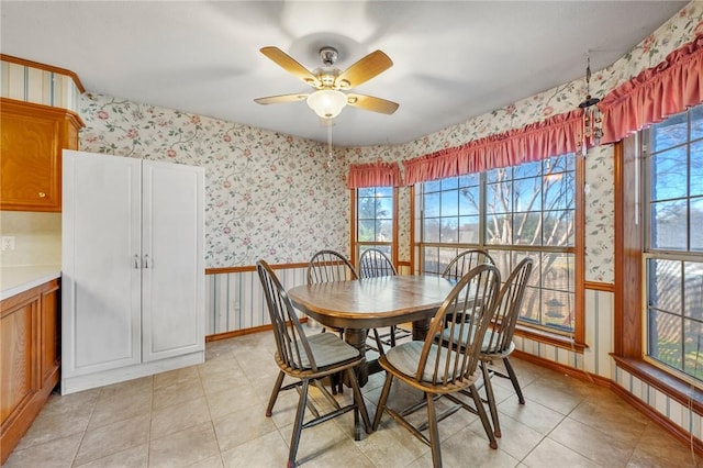 tiled dining space featuring ceiling fan