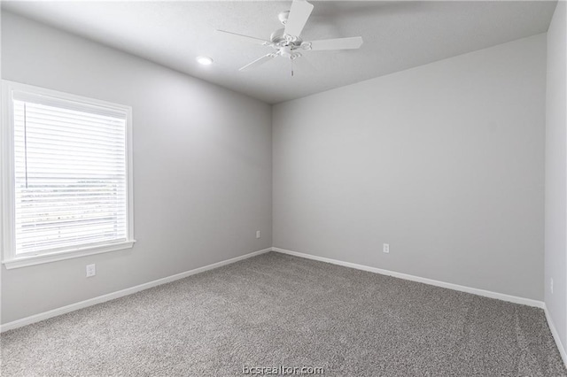 carpeted empty room featuring ceiling fan