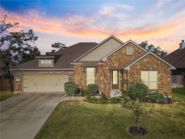 view of front of home featuring a garage and a lawn