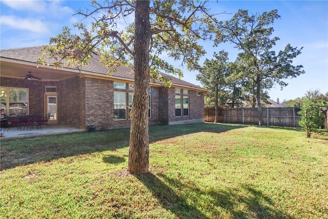 view of yard with ceiling fan and a patio area