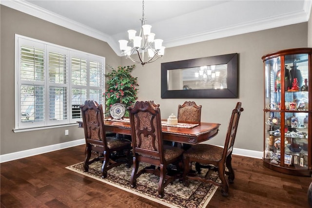 dining area featuring dark hardwood / wood-style flooring, an inviting chandelier, and crown molding