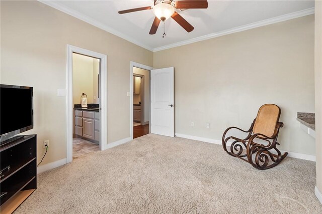 sitting room featuring baseboards, carpet floors, ceiling fan, and crown molding