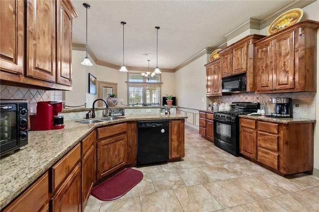 kitchen featuring a sink, black appliances, a peninsula, and brown cabinetry