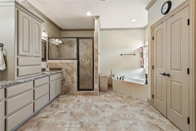 bathroom with vanity, a shower stall, a bath, and ornamental molding