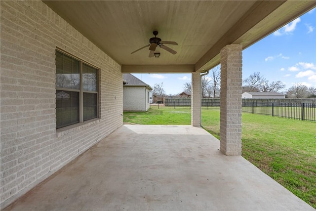 view of patio with ceiling fan and fence