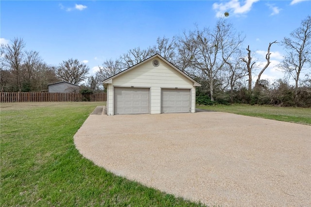 detached garage featuring fence